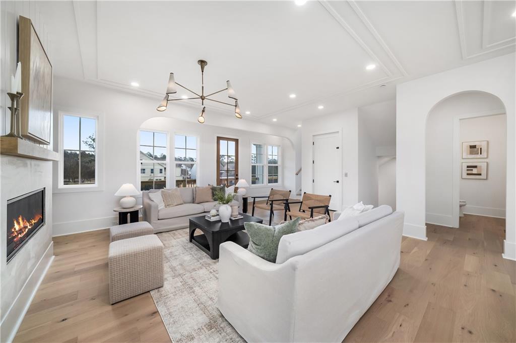 245 Lask Lane Milton, GA 30004 - Photo 17 of 87 a living room with furniture fireplace and a chandelier