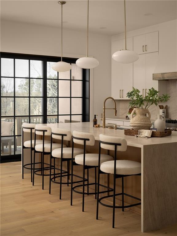 245 Lask Lane Milton, GA 30004 - Photo 23 of 87 a kitchen with a table chairs stove and cabinets