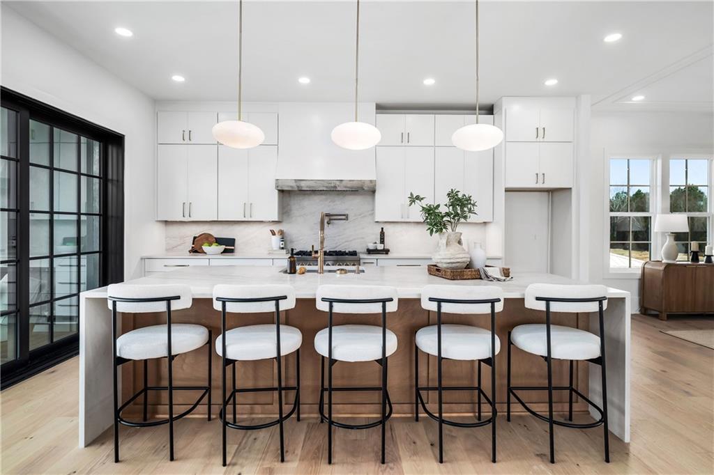 245 Lask Lane Milton, GA 30004 - Photo 24 of 87 a kitchen with a table chairs stove and microwave