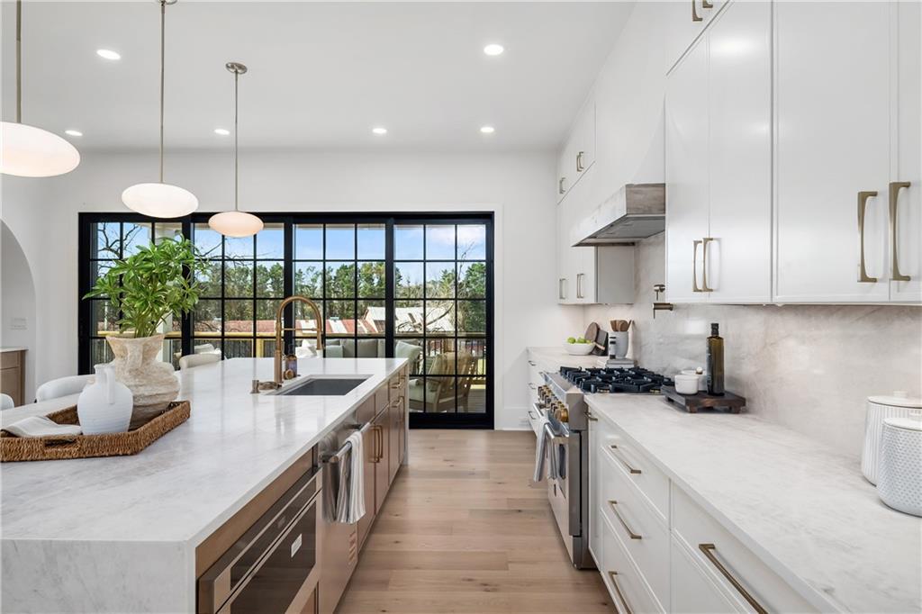 245 Lask Lane Milton, GA 30004 - Photo 27 of 87 a kitchen with stainless steel appliances granite countertop a sink a stove and a wooden floors