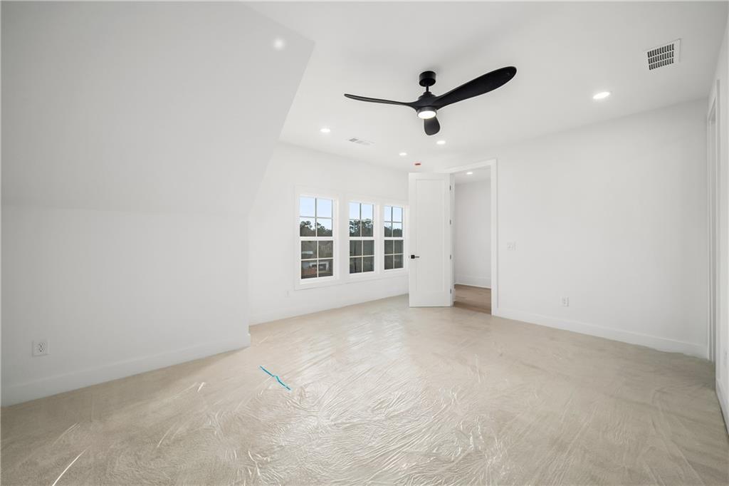 245 Lask Lane Milton, GA 30004 - Photo 54 of 87 an empty room with a ceiling fan and window