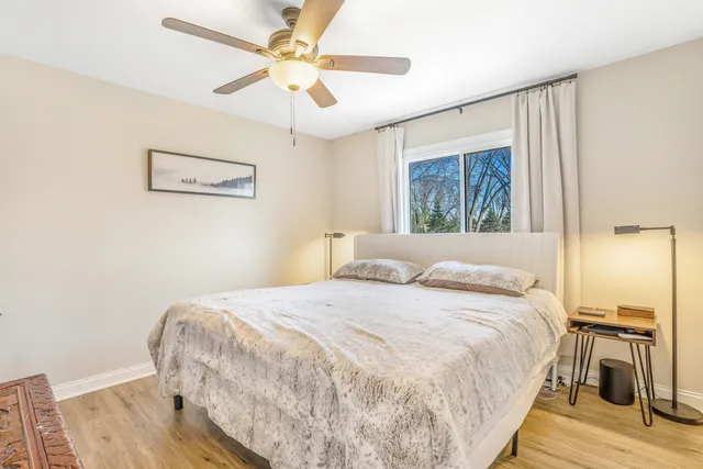 a bedroom with a bed and a ceiling fan