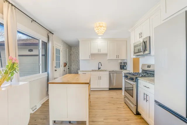 a kitchen with a stove a sink and a refrigerator