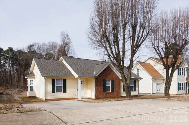 a front view of a house with a yard and trees