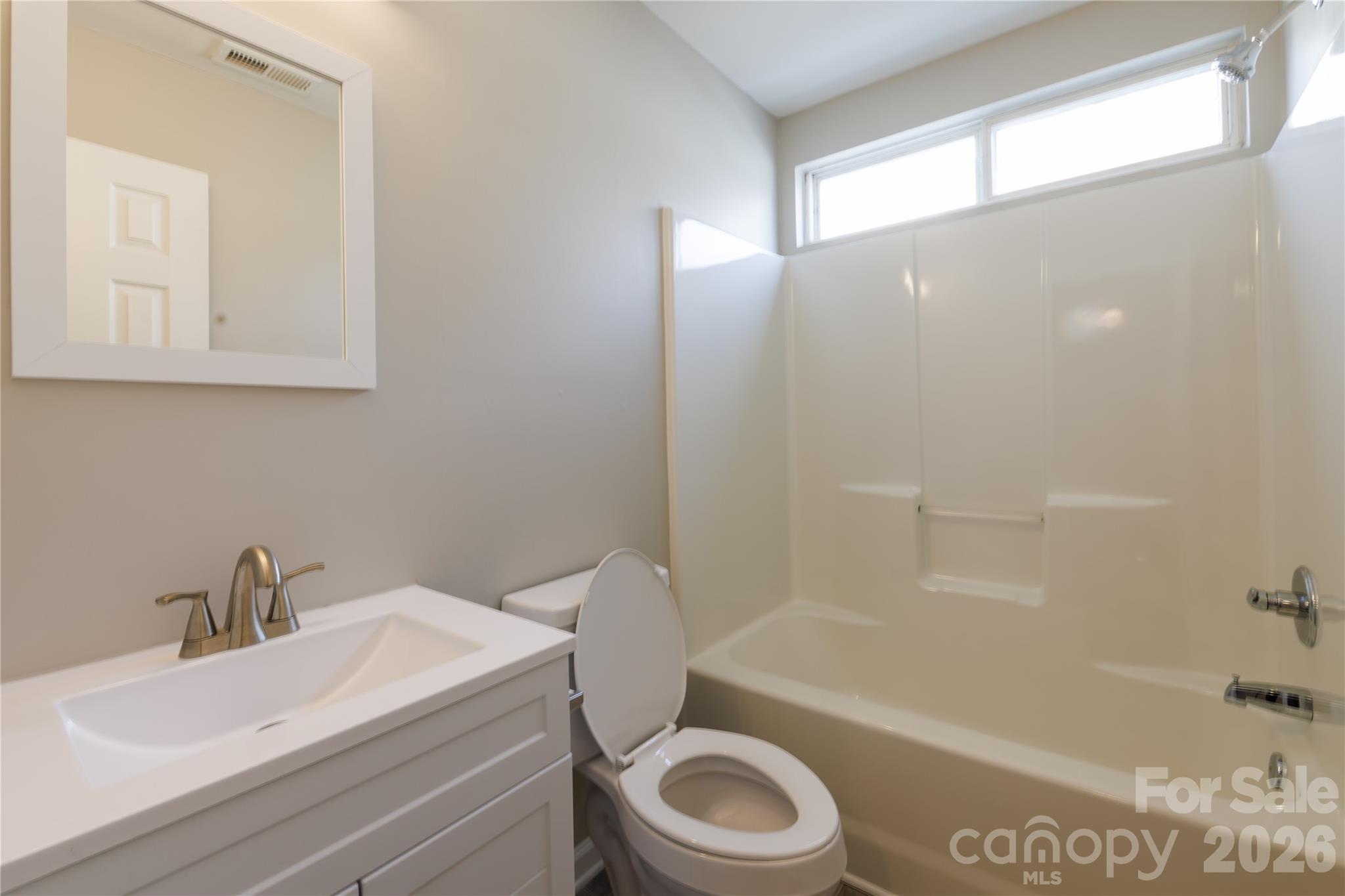 7111 Rumple Road Charlotte, NC 28262 - Photo 16 of 18 a bathroom with a sink a toilet and bathtub