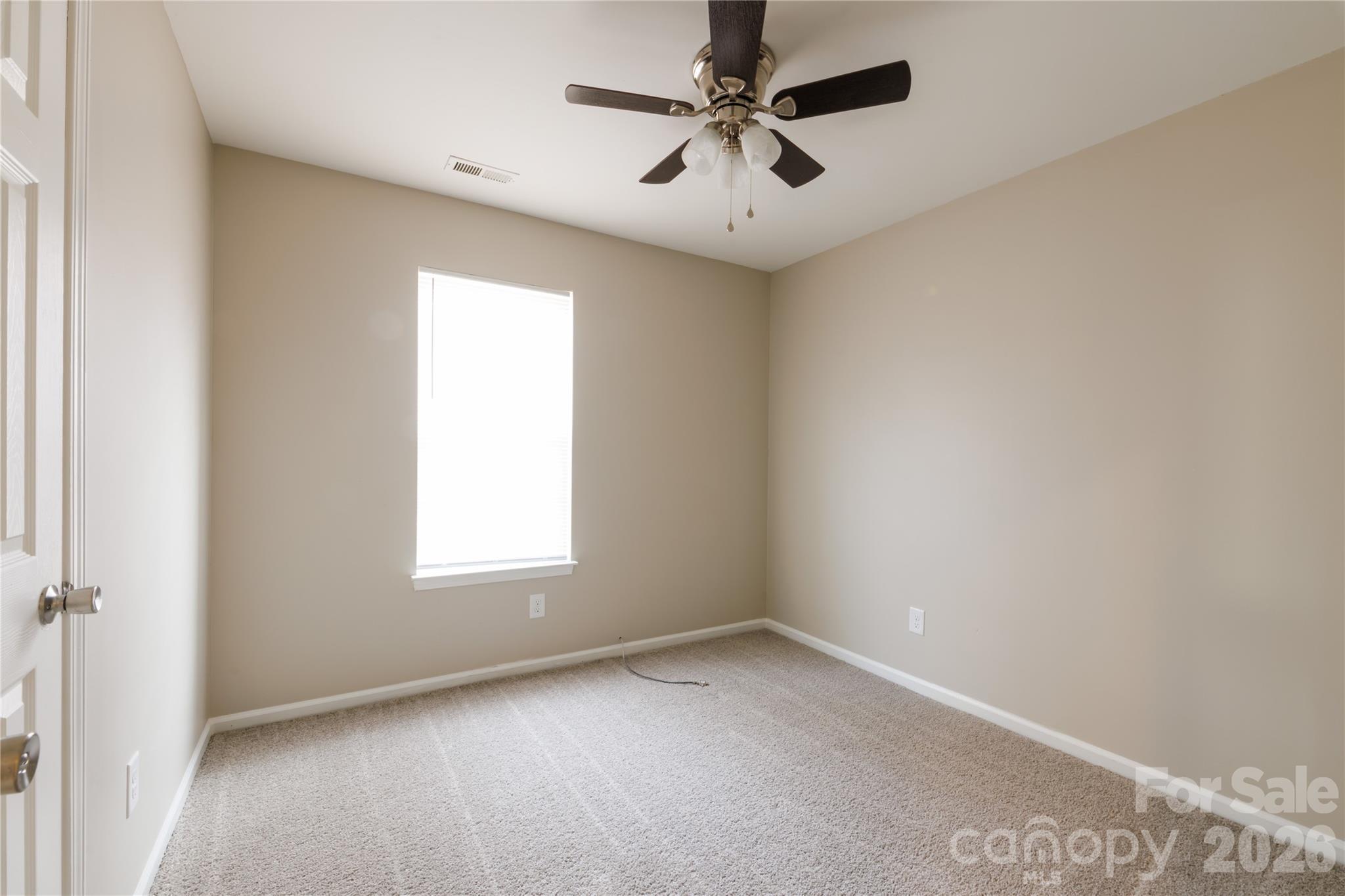 7111 Rumple Road Charlotte, NC 28262 - Photo 10 of 18 an empty room with a window and a fan