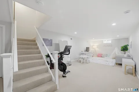 a living room with furniture and stairs