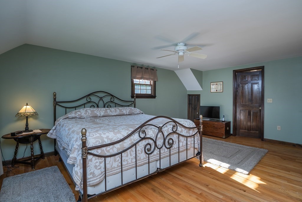 53 Yankee Circle Westfield, MA 01085 - Photo 24 of 42 a bedroom with a bed and a chandelier