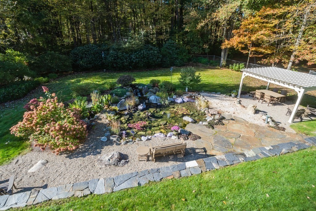 53 Yankee Circle Westfield, MA 01085 - Photo 41 of 42 a view of a garden with a fountain and a bench
