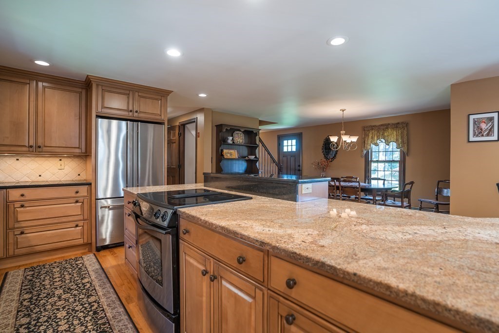 53 Yankee Circle Westfield, MA 01085 - Photo 7 of 42 a kitchen with stainless steel appliances granite countertop a stove a sink and a refrigerator