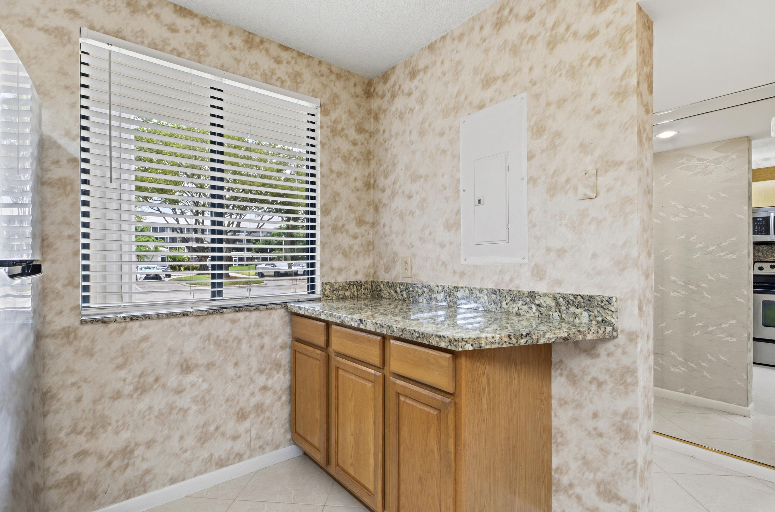 6145 Balboa Circle, Unit 103 Boca Raton, FL 33433 - Photo 6 of 31 a bathroom with a granite countertop sink and a shower