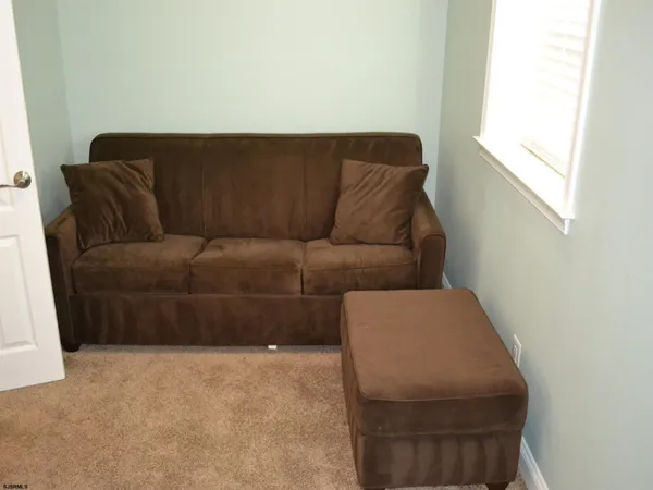 a living room with a couch and a window