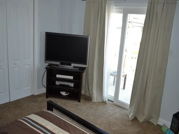 a room with wooden floor and windows