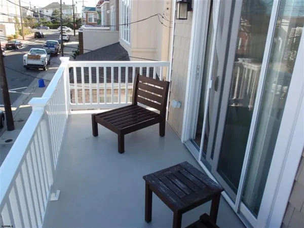 a view of stairs and hall with wooden floor