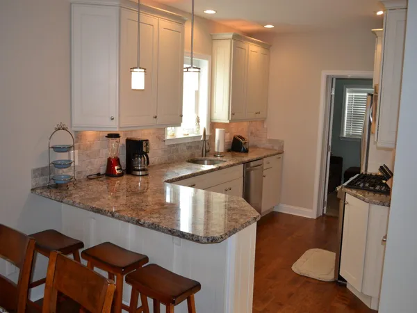 a kitchen with a sink refrigerator and microwave