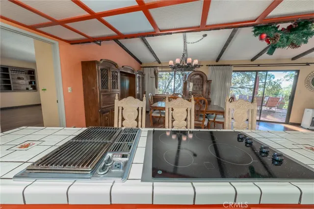 a view of an empty room with glass door and wooden floor
