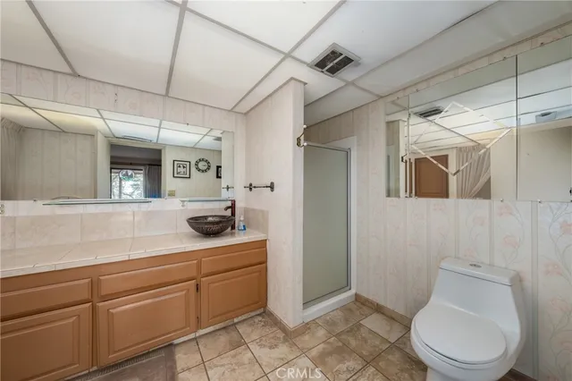 a bathroom with a sink a mirror and a shower