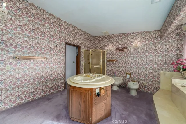 a spacious bedroom with a bed and a couch