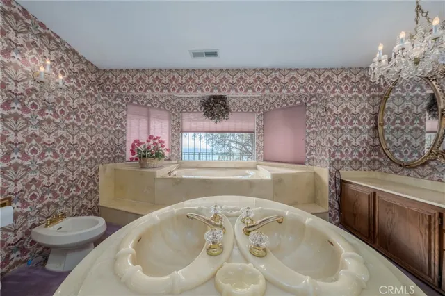 a large bedroom with a bed and furniture