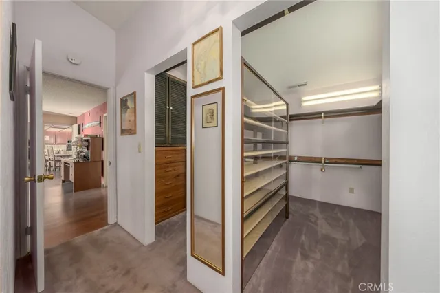 a spacious bedroom with a bed and wooden floor