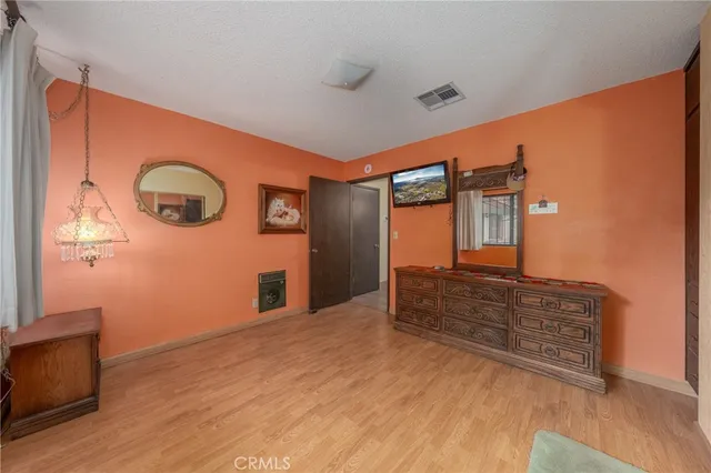 a view of a backyard with table and chairs and a large tree