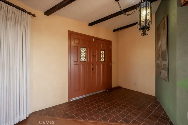 a dining room with furniture a chandelier and wooden floor