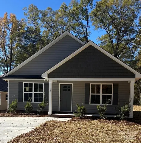 a front view of a house with garden and porch