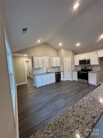 a view of kitchen and wooden floor