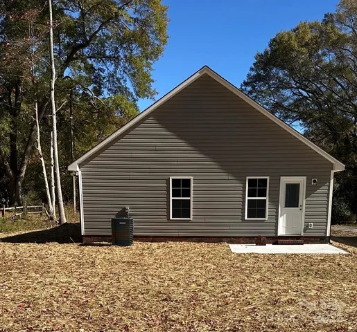 a backyard of a house with large tree