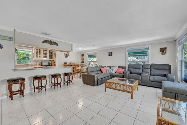 a living room with furniture and a dining table