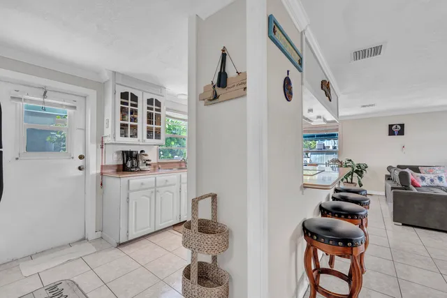 a kitchen with white cabinets and black appliances