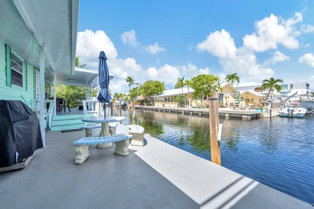 a view of a lake with couches chairs and a table