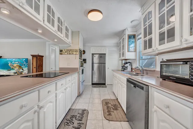 a kitchen with stainless steel appliances a sink and a refrigerator
