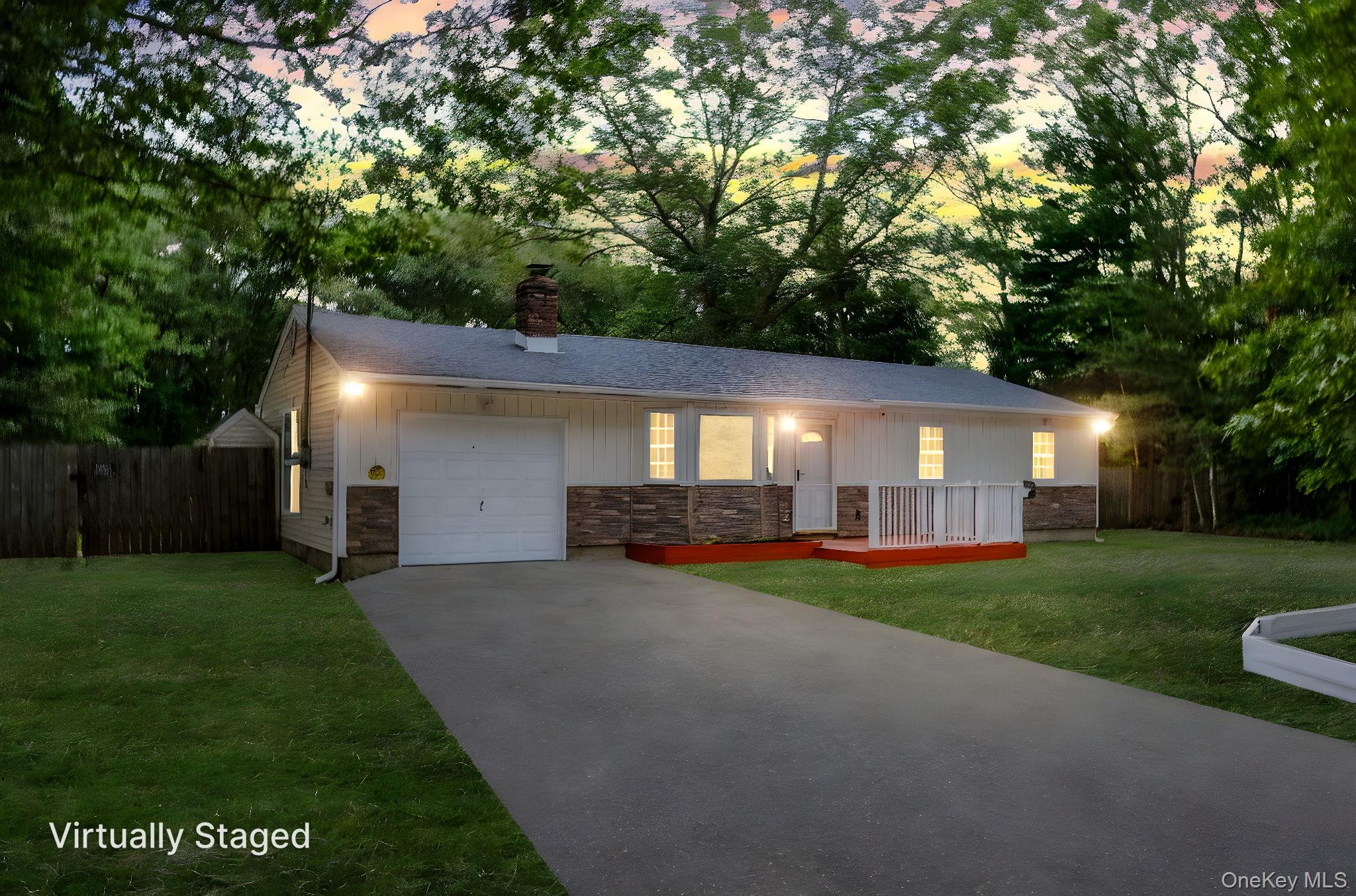 Single story home with a garage, driveway, a chimney, a deck, and roof with shingles