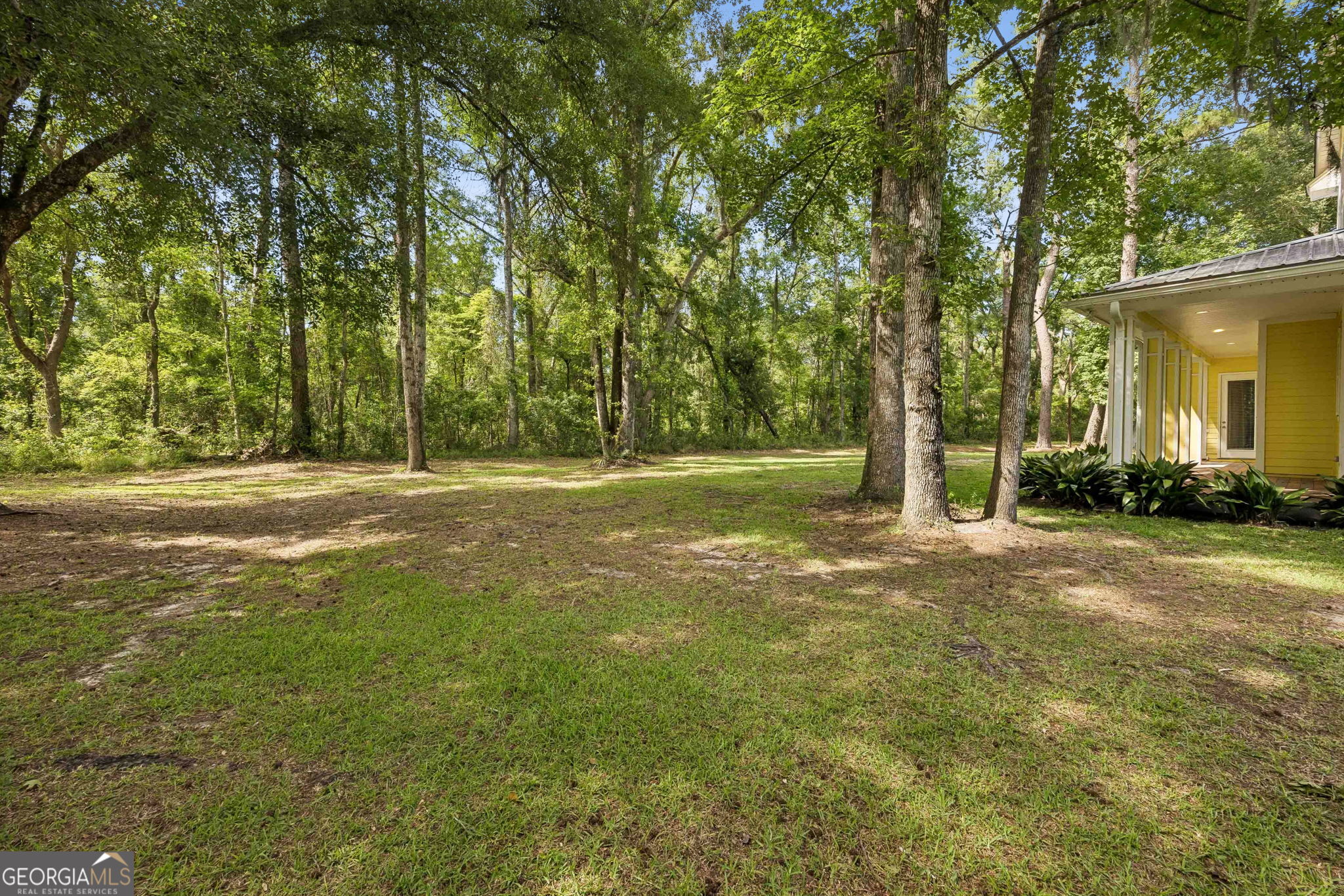 706 Hopewell Point Road White Oak, GA 31568 - Photo 72 of 84 Enjoy privacy and natural beauty with a spacious backyard bordered by mature trees that create a peaceful setting year-round.