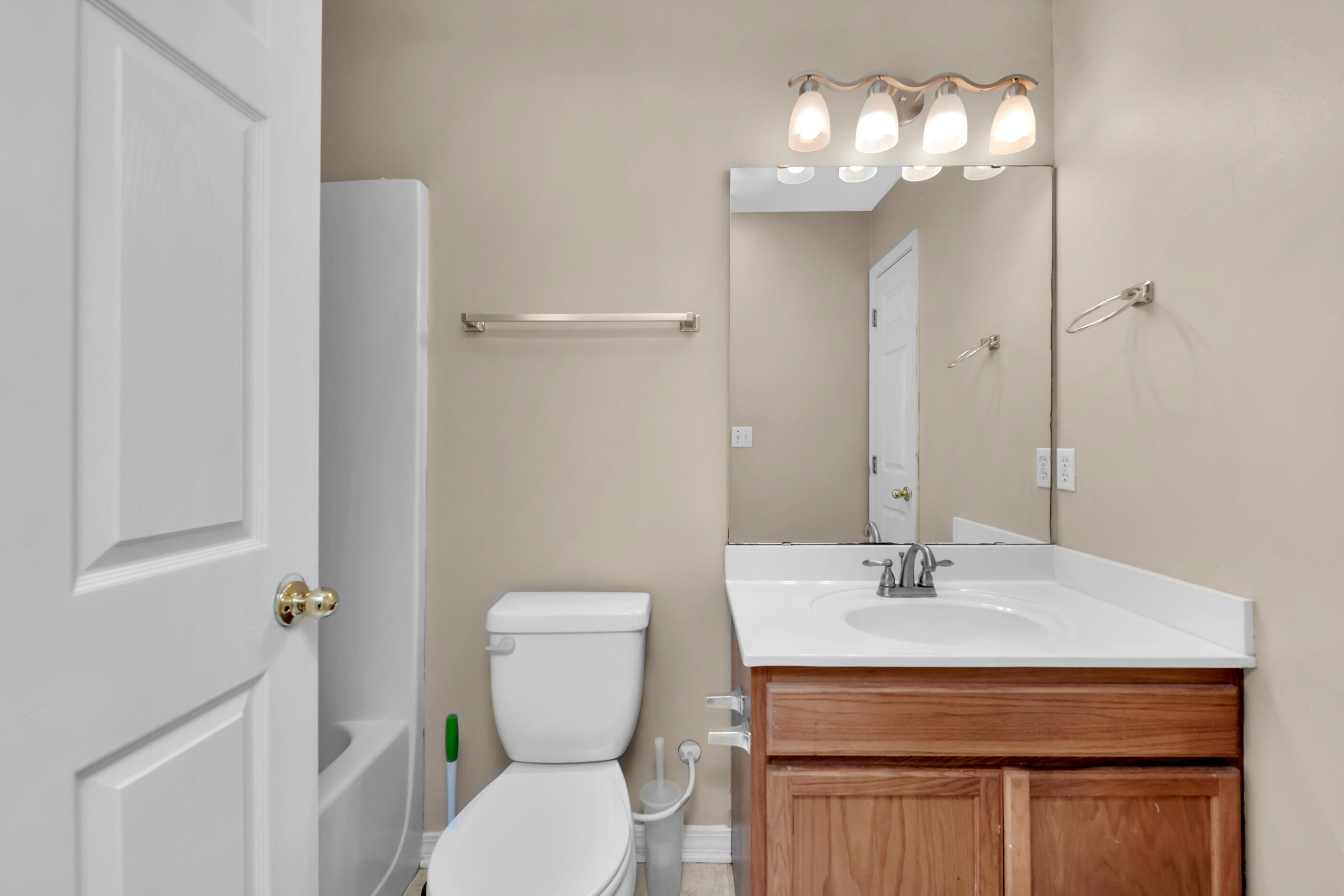 706 Brock Avenue Crestview, FL 32539 - Photo 11 of 18 a bathroom with a toilet sink and mirror