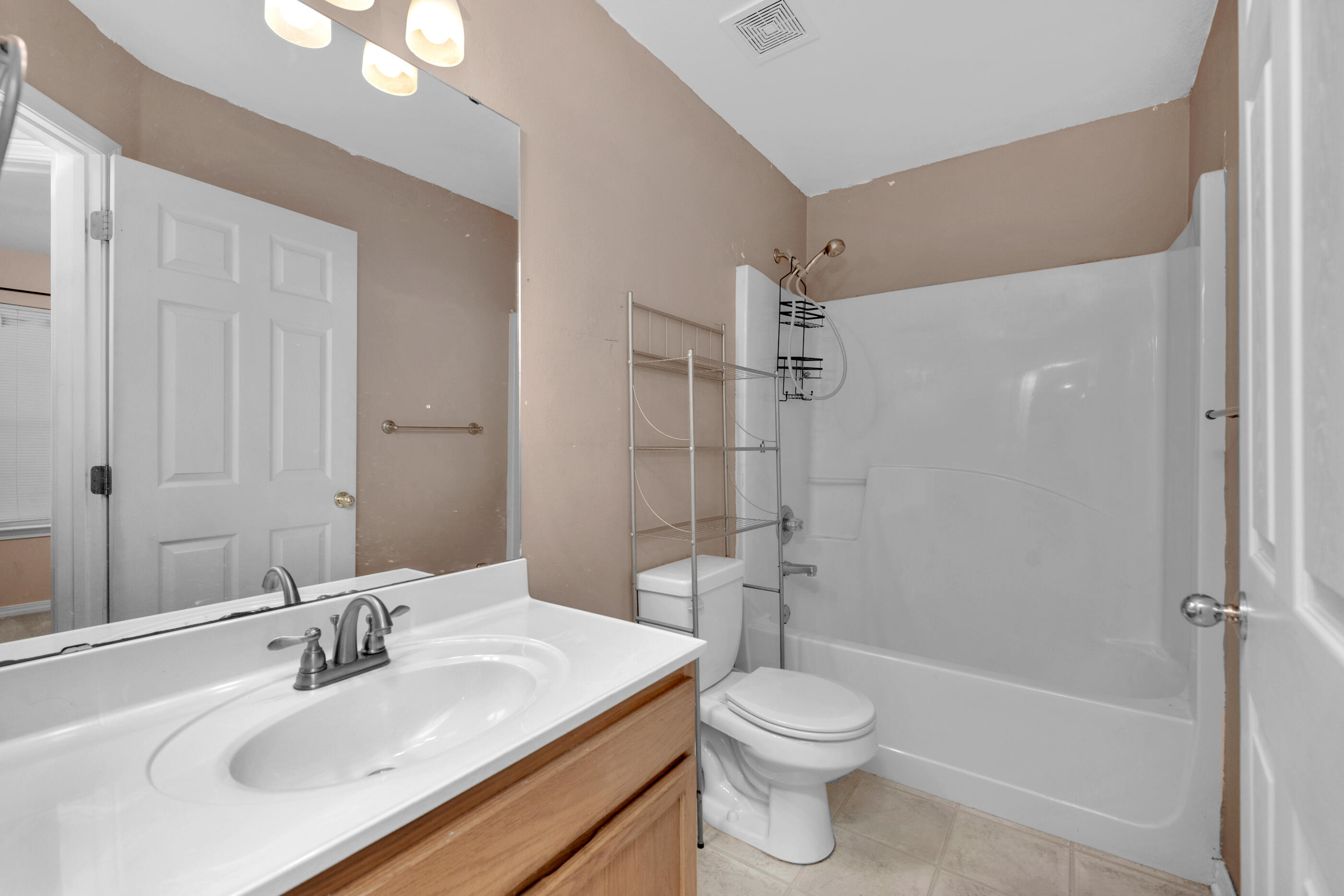 706 Brock Avenue Crestview, FL 32539 - Photo 14 of 18 a bathroom with a sink toilet and shower