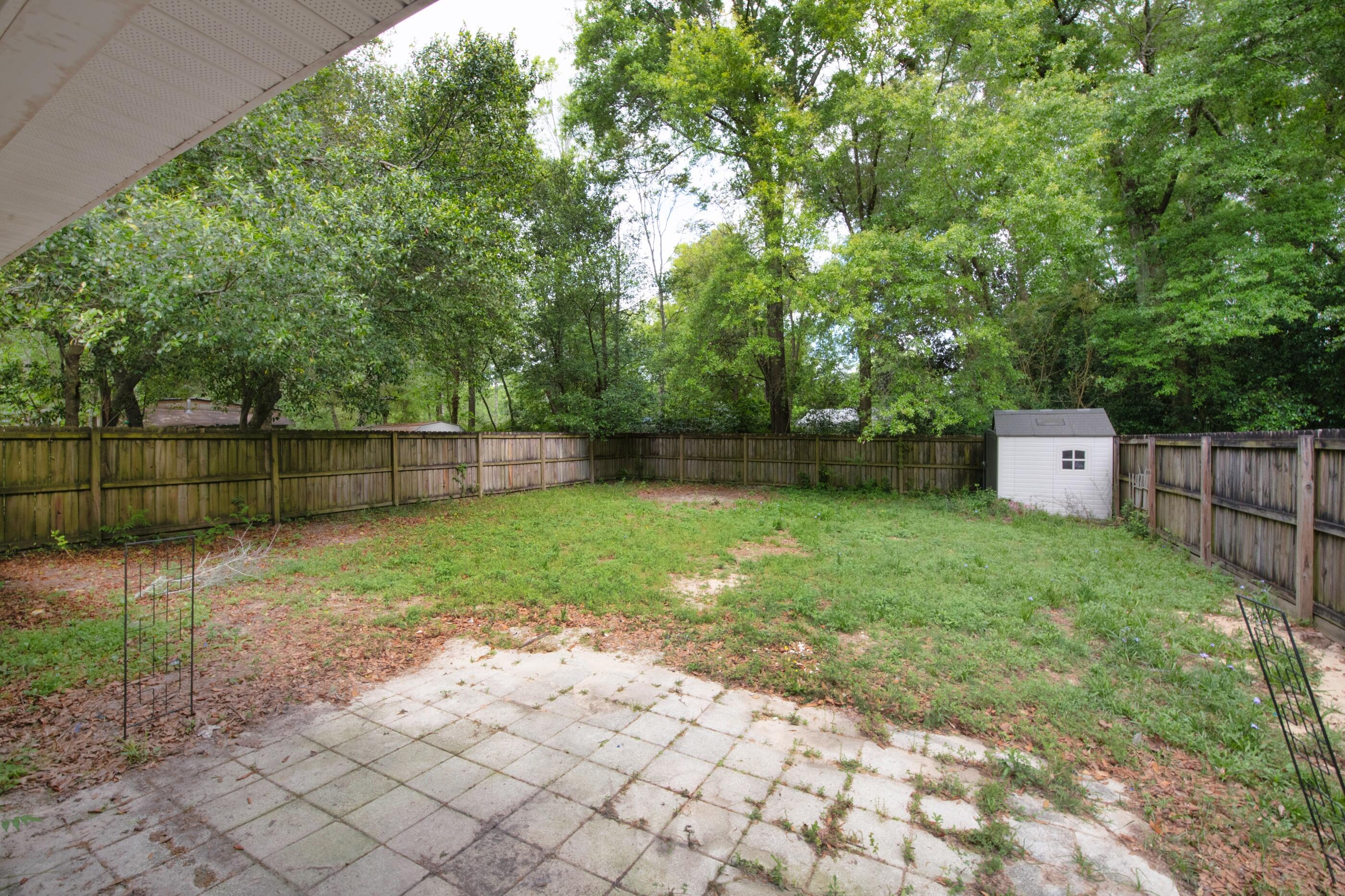 706 Brock Avenue Crestview, FL 32539 - Photo 15 of 18 a backyard of a house with lots of green space