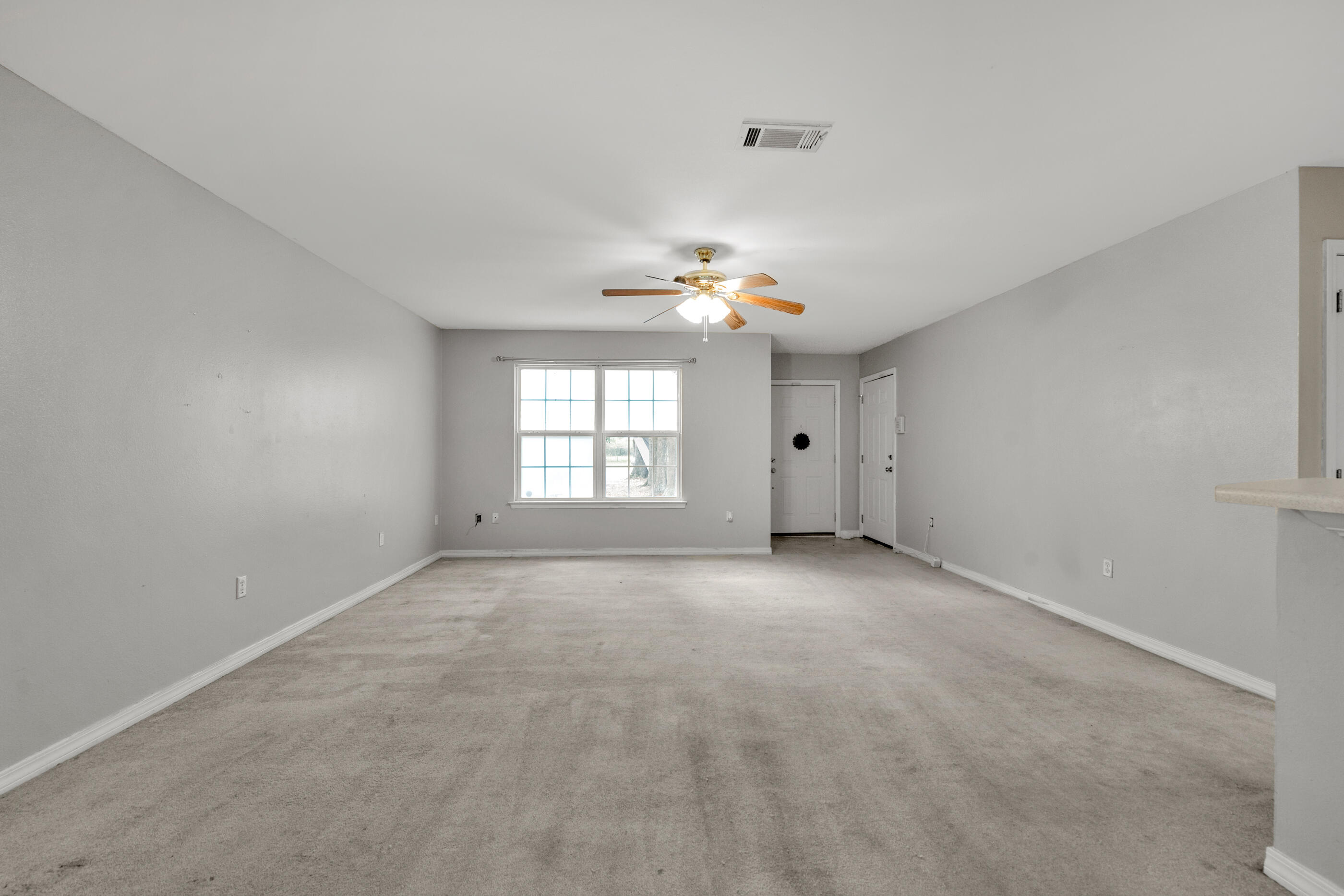 706 Brock Avenue Crestview, FL 32539 - Photo 3 of 18 a view of an empty room with a window