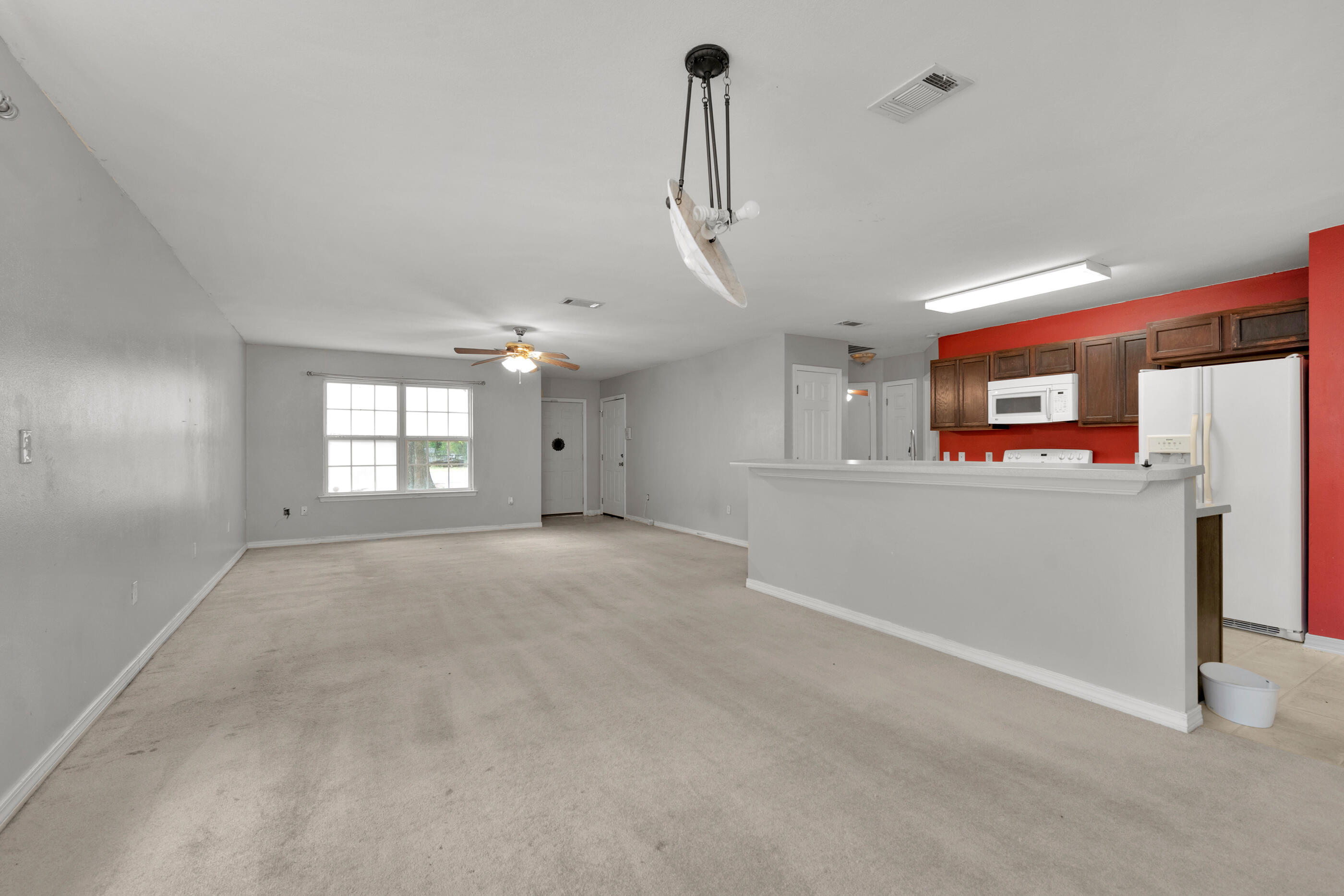 706 Brock Avenue Crestview, FL 32539 - Photo 4 of 18 a view of a room with stainless steel appliances granite countertop cabinets and a window