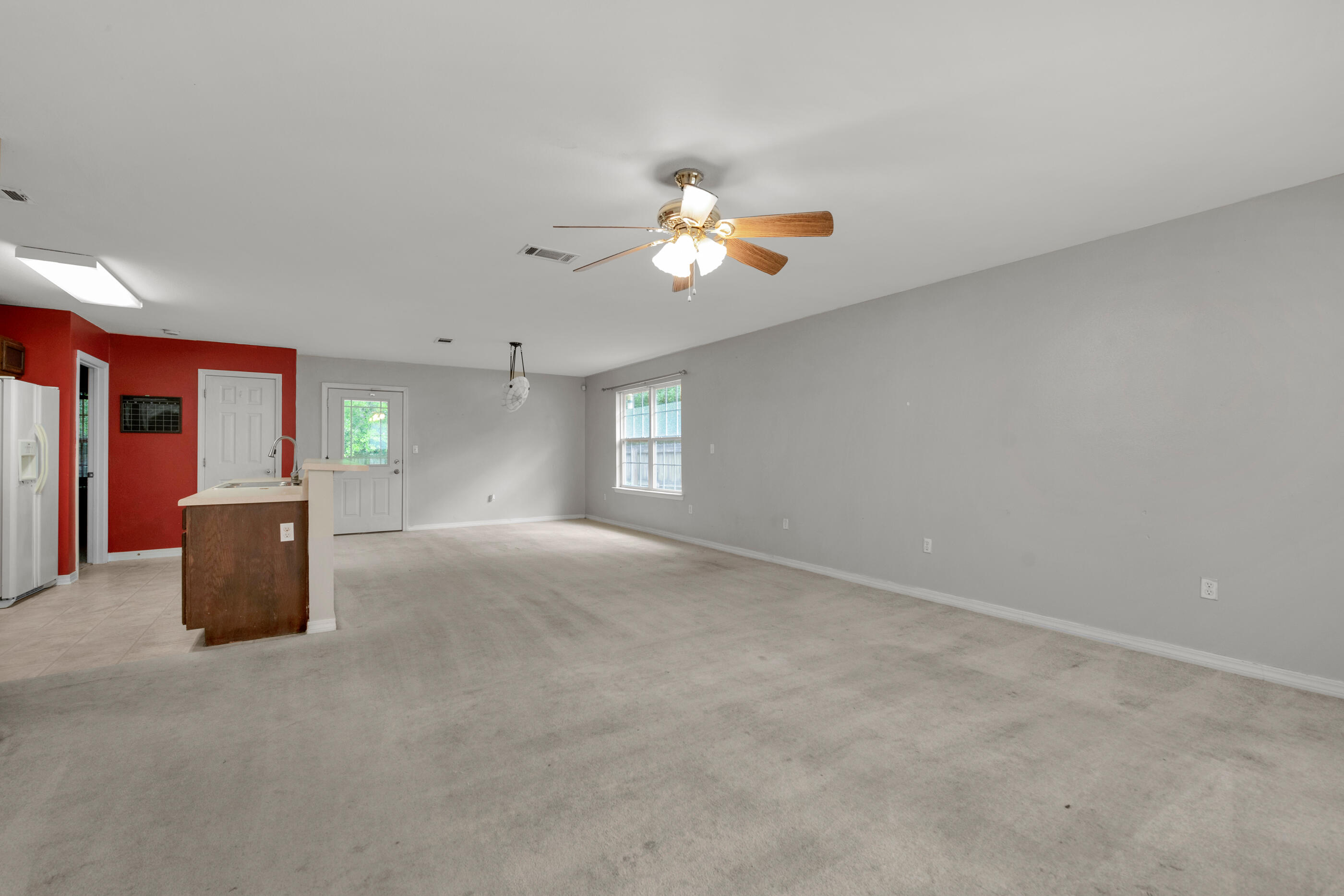 706 Brock Avenue Crestview, FL 32539 - Photo 5 of 18 a view of a room with a ceiling fan and window
