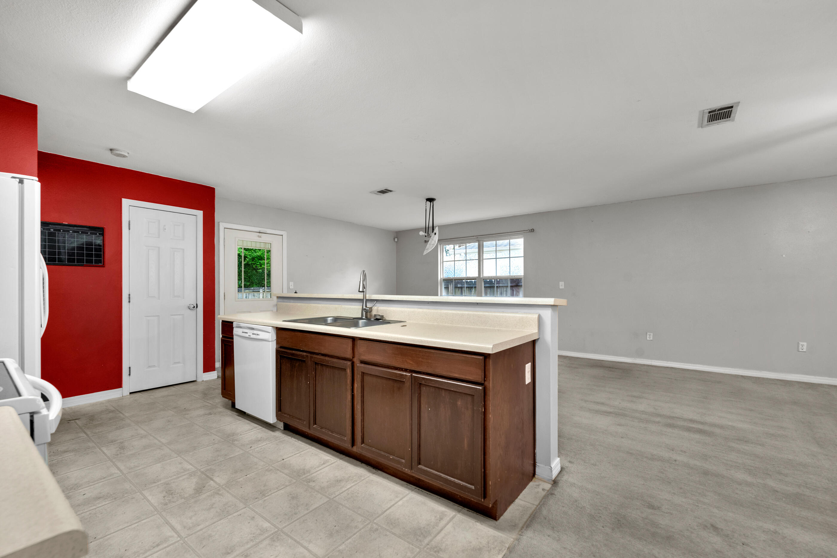 706 Brock Avenue Crestview, FL 32539 - Photo 6 of 18 a kitchen with stainless steel appliances granite countertop a sink and a refrigerator