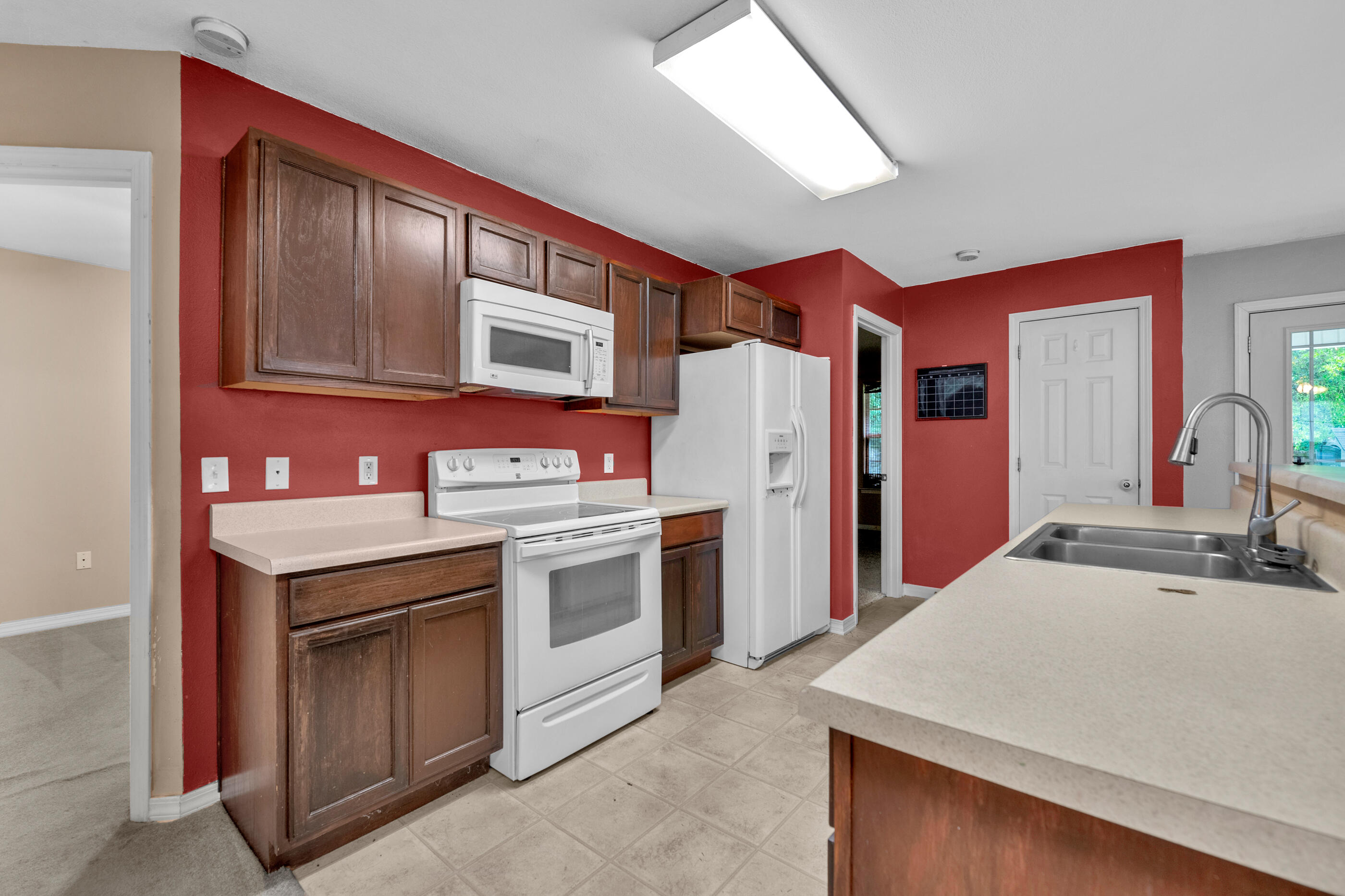 706 Brock Avenue Crestview, FL 32539 - Photo 7 of 18 a kitchen with stainless steel appliances granite countertop a stove and a refrigerator
