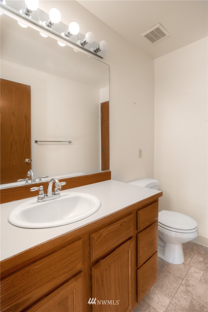 619 Southwest Normandy Road Normandy Park, WA 98166 - Photo 16 of 24 a bathroom with a sink a toilet and a mirror