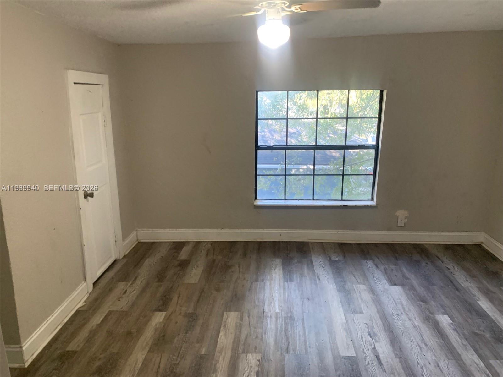 1129 Grothe Street Jacksonville, FL 32209 - Photo 16 of 21 an empty room with wooden floor and windows