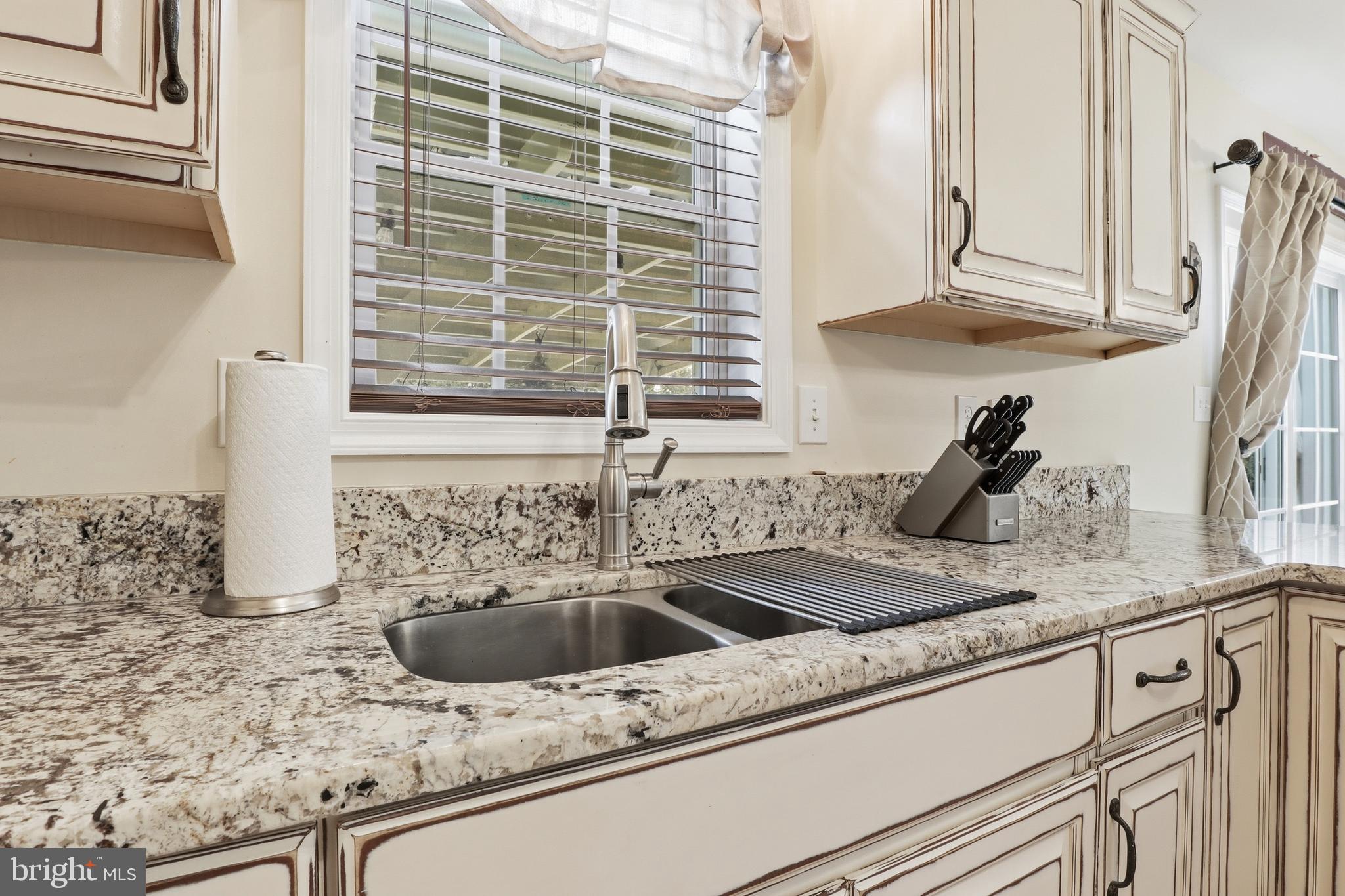 6083 Jennifer Lane Spring Grove, PA 17362 - Photo 16 of 61 a kitchen with granite countertop a sink and a white wooden cabinets