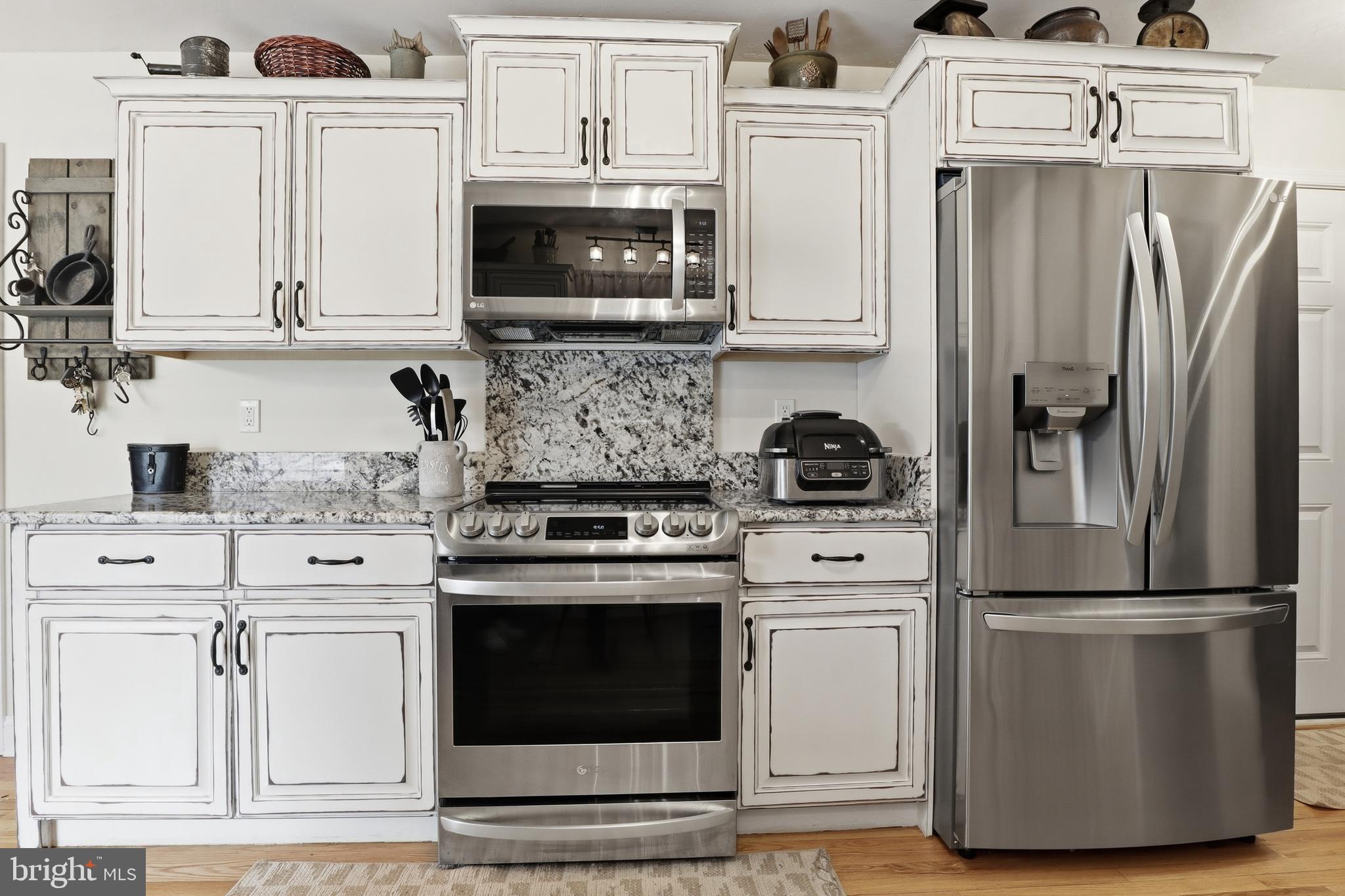 6083 Jennifer Lane Spring Grove, PA 17362 - Photo 17 of 61 a kitchen with stainless steel appliances granite countertop a refrigerator a stove a microwave and cabinets