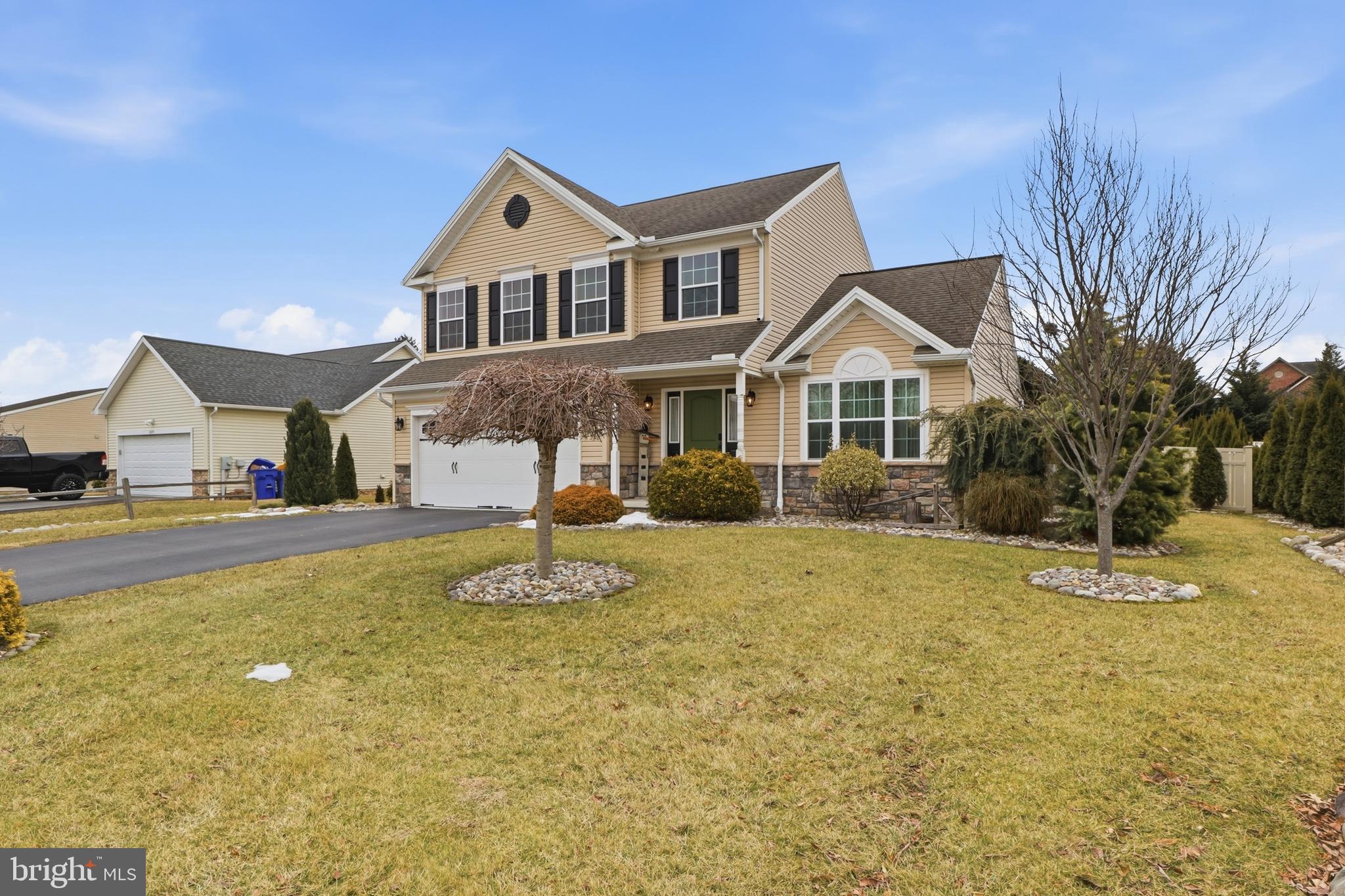 6083 Jennifer Lane Spring Grove, PA 17362 - Photo 4 of 61 a front view of a house with a yard table and chairs