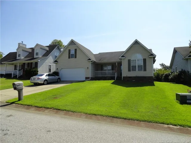 a front view of a house with a yard and porch