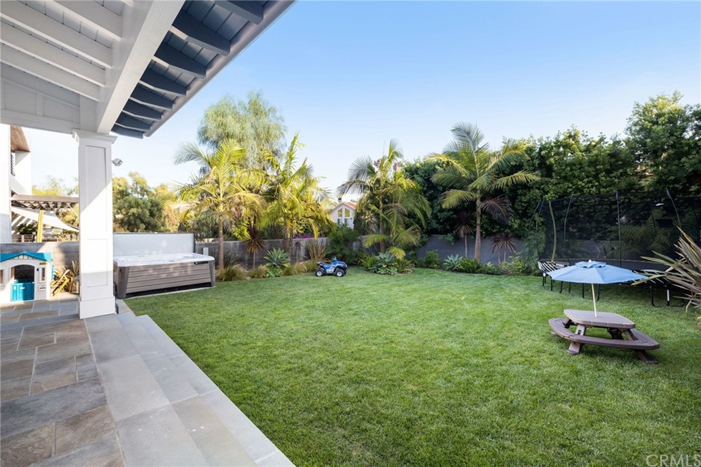1120 6th Street Manhattan Beach, CA 90266 - Photo 27 of 64 a view of a backyard with table and chairs under an umbrella with a small yard